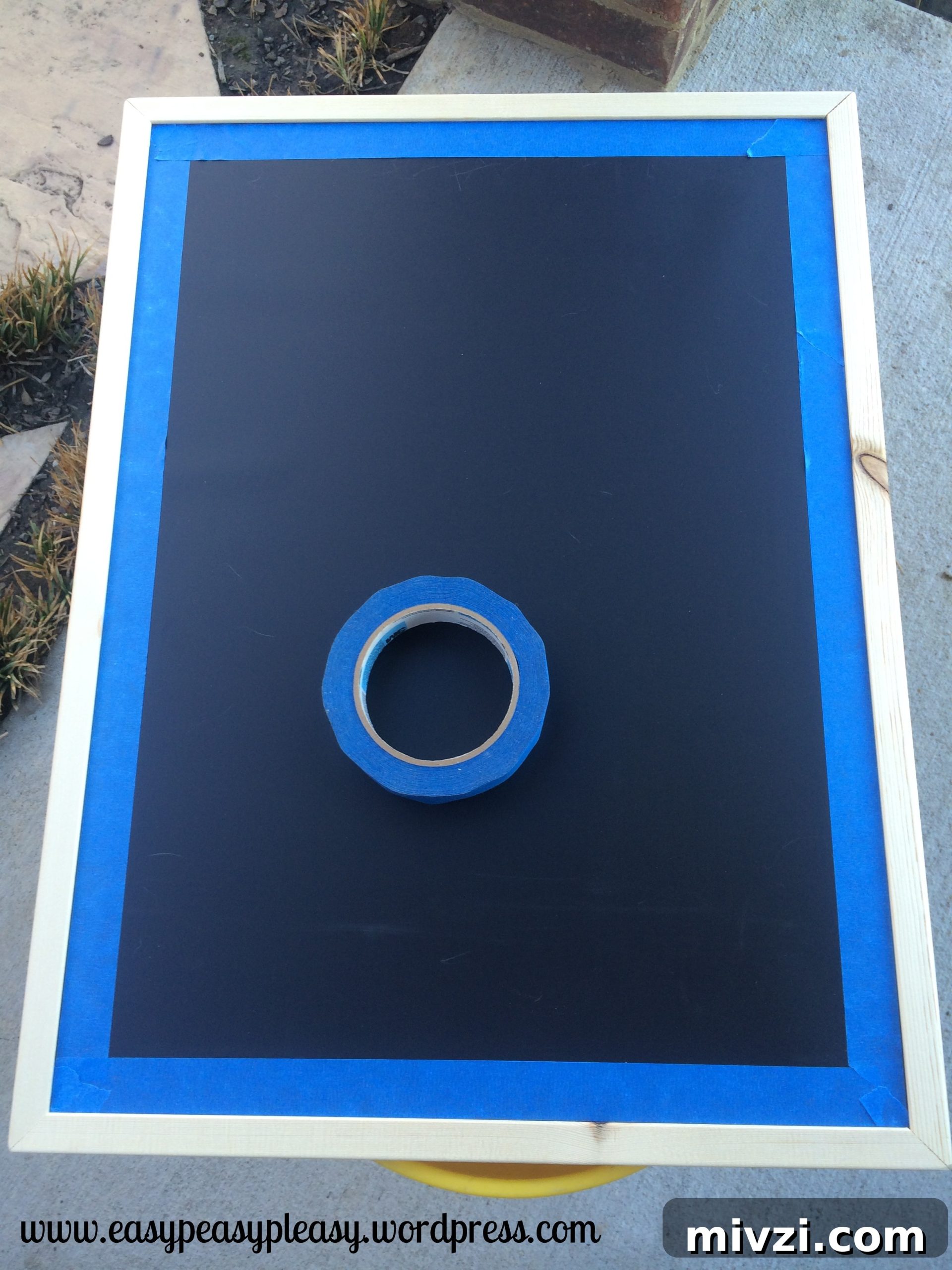 Feature Friday: DIY Pregnancy Announcement Ideas with Family & Friends 3 Using painters tape to paint chalkboard frame to tell people you are pregnant
