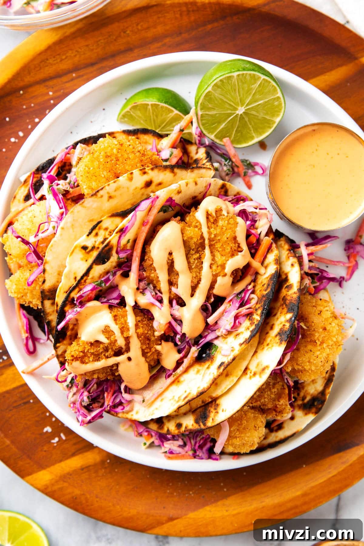 Crispy Panko Shrimp Tacos with Tangy Slaw 6 Fried shrimp tacos with shredded carrots, red cabbage, cilantro, lime juice, crispy Panko fried shrimp, and spicy creamy sauce