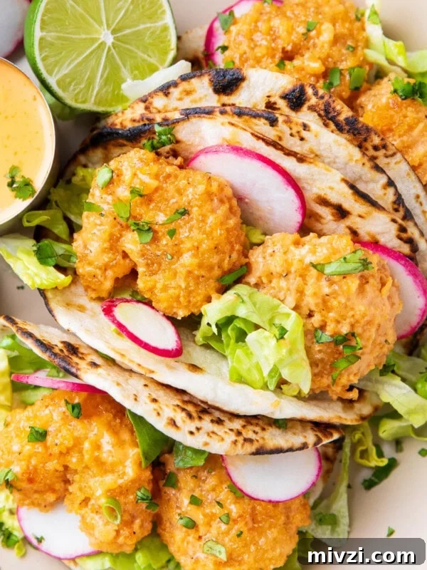 Crispy Panko Shrimp Tacos with Tangy Slaw 7 this bang bang taco recipe includes generously sauced shrimp is tucked in a charred taco with fresh lettuce, a squeeze of lime, and lots of bang bang sauce