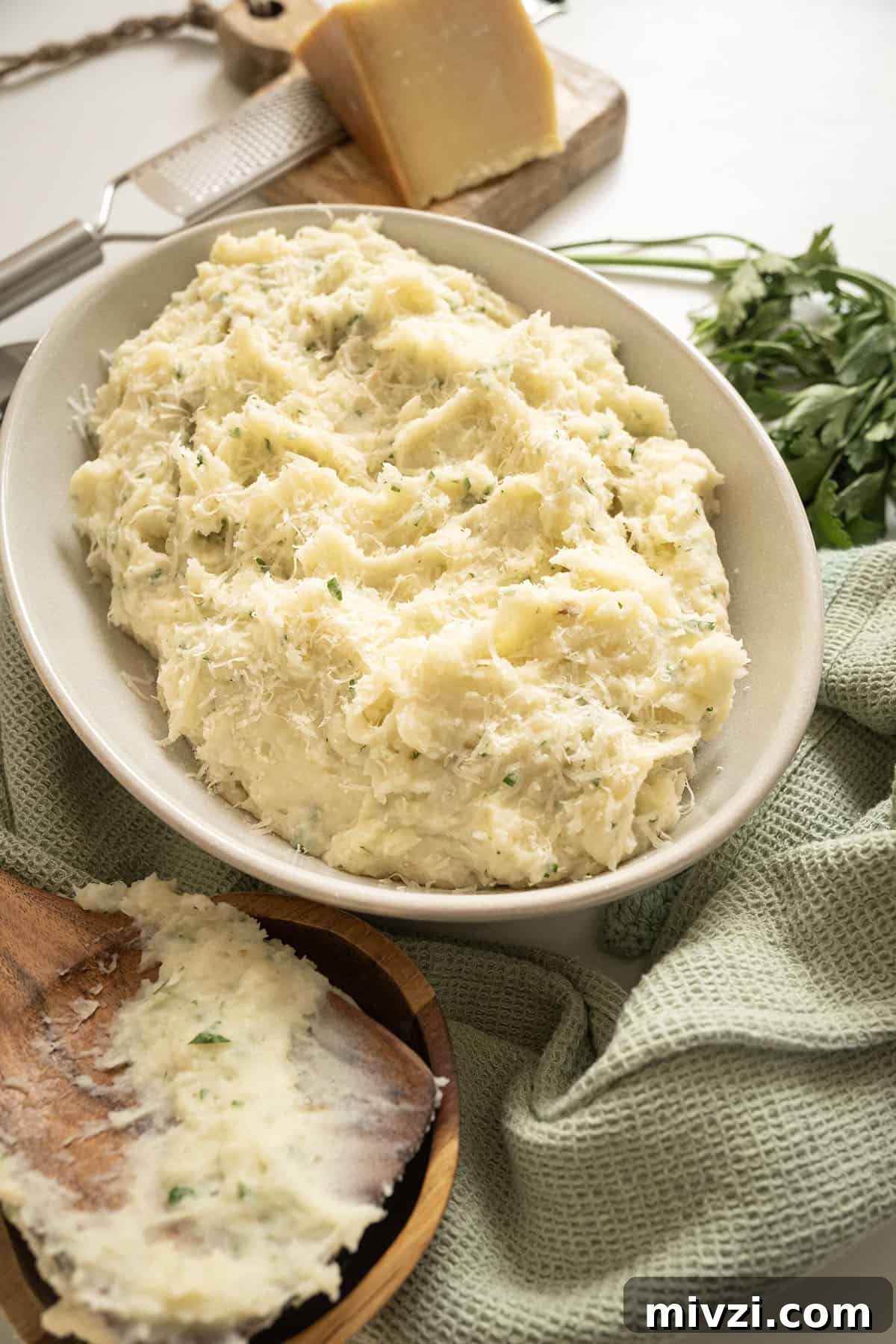 Garlic Parmesan Mashed Potatoes Recipe — Creamy Comfort Side Dish 12 Garlic parmesan mashed potatoes in a bowl.