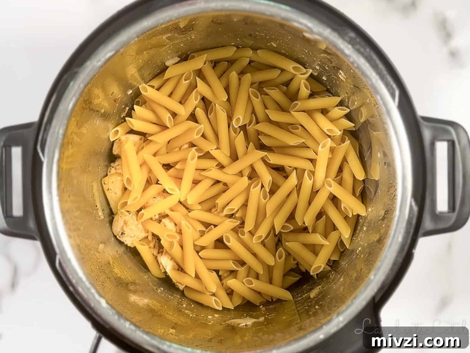 dry penne pasta and chicken broth in an Instant Pot before pressure cooking.