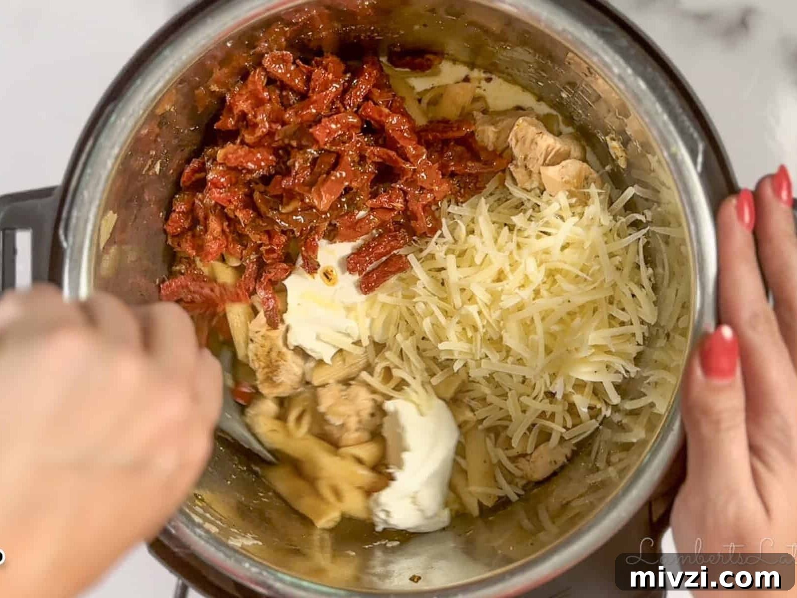 mixing parmesan cheese, cream cheese, sun-dried tomatoes in an instant pot.