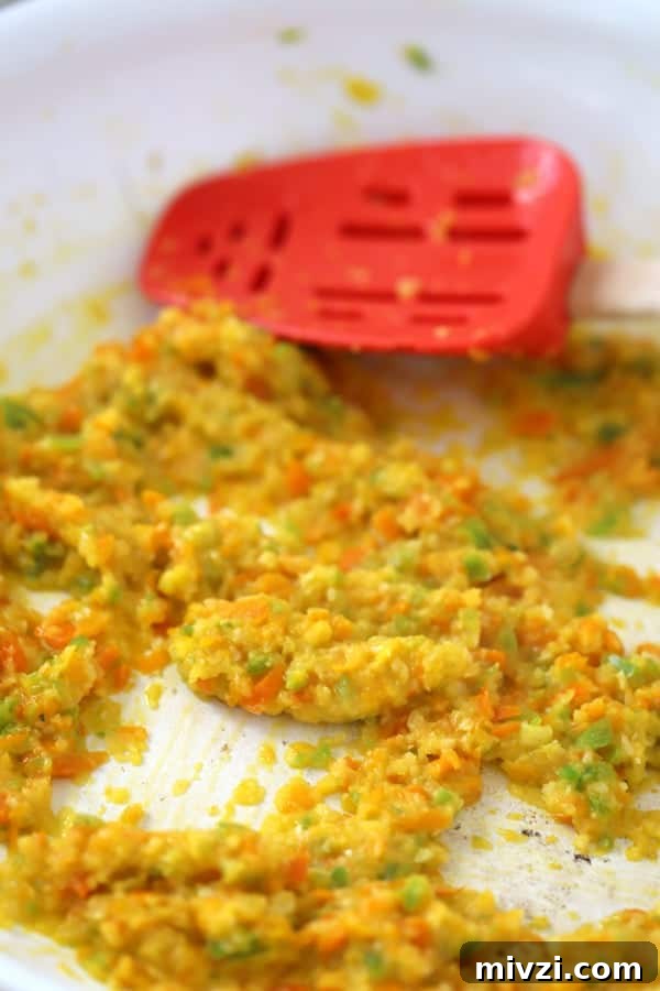 minced Onions, peppers and garlic sauteed in a pan, ready to make this cheddars cheese dip recipe.