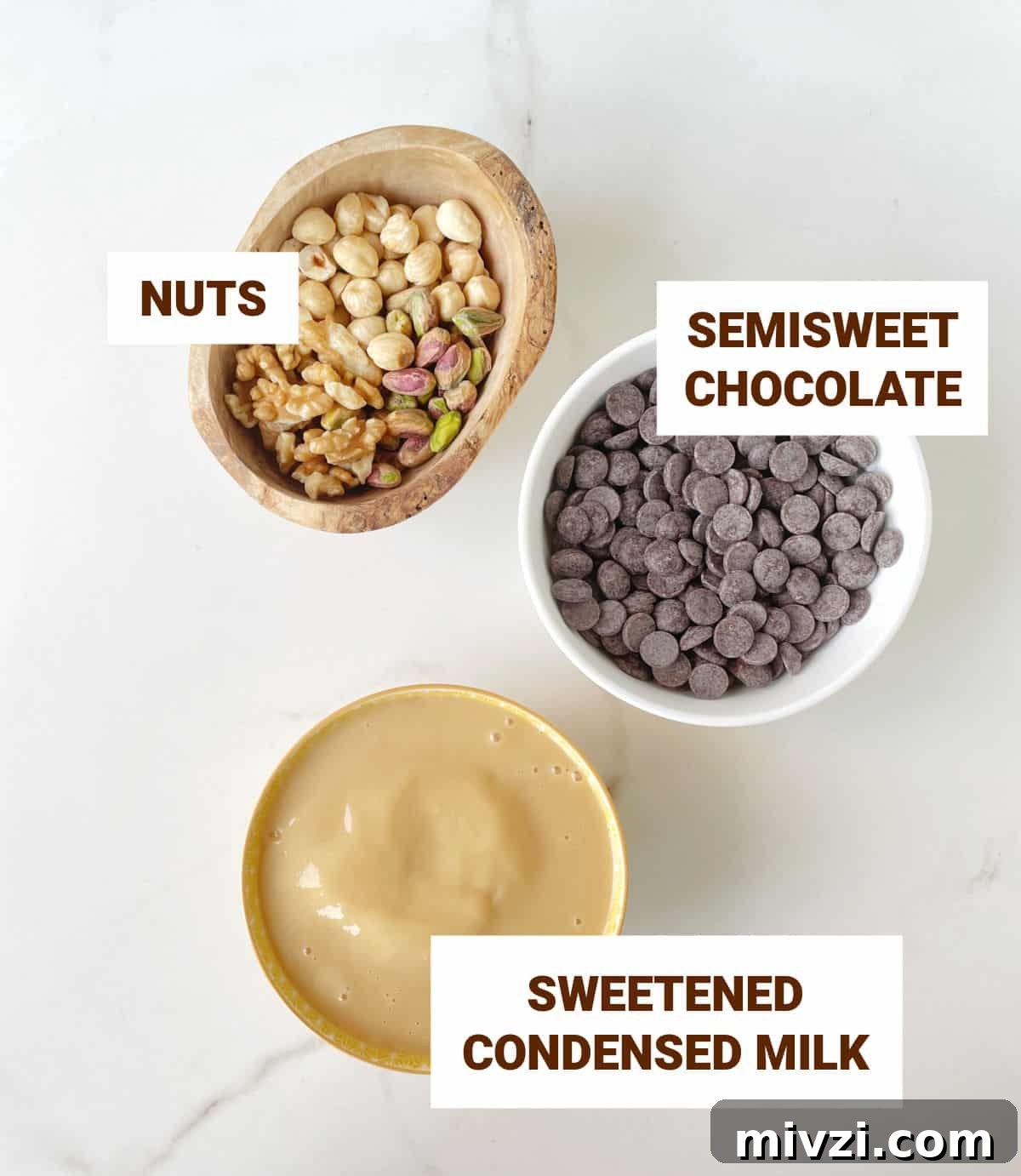 Quick Microwave Chocolate Fudge: Ready in Minutes 4 Three bowls on a white marble surface with ingredients for fudge: chocolate chips, condensed milk, and nuts.