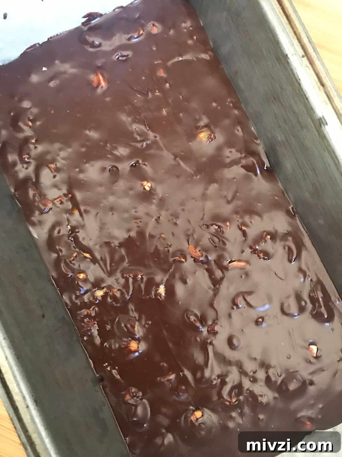 Quick Microwave Chocolate Fudge: Ready in Minutes 5 Metal loaf pan with dark chocolate fudge mixture.