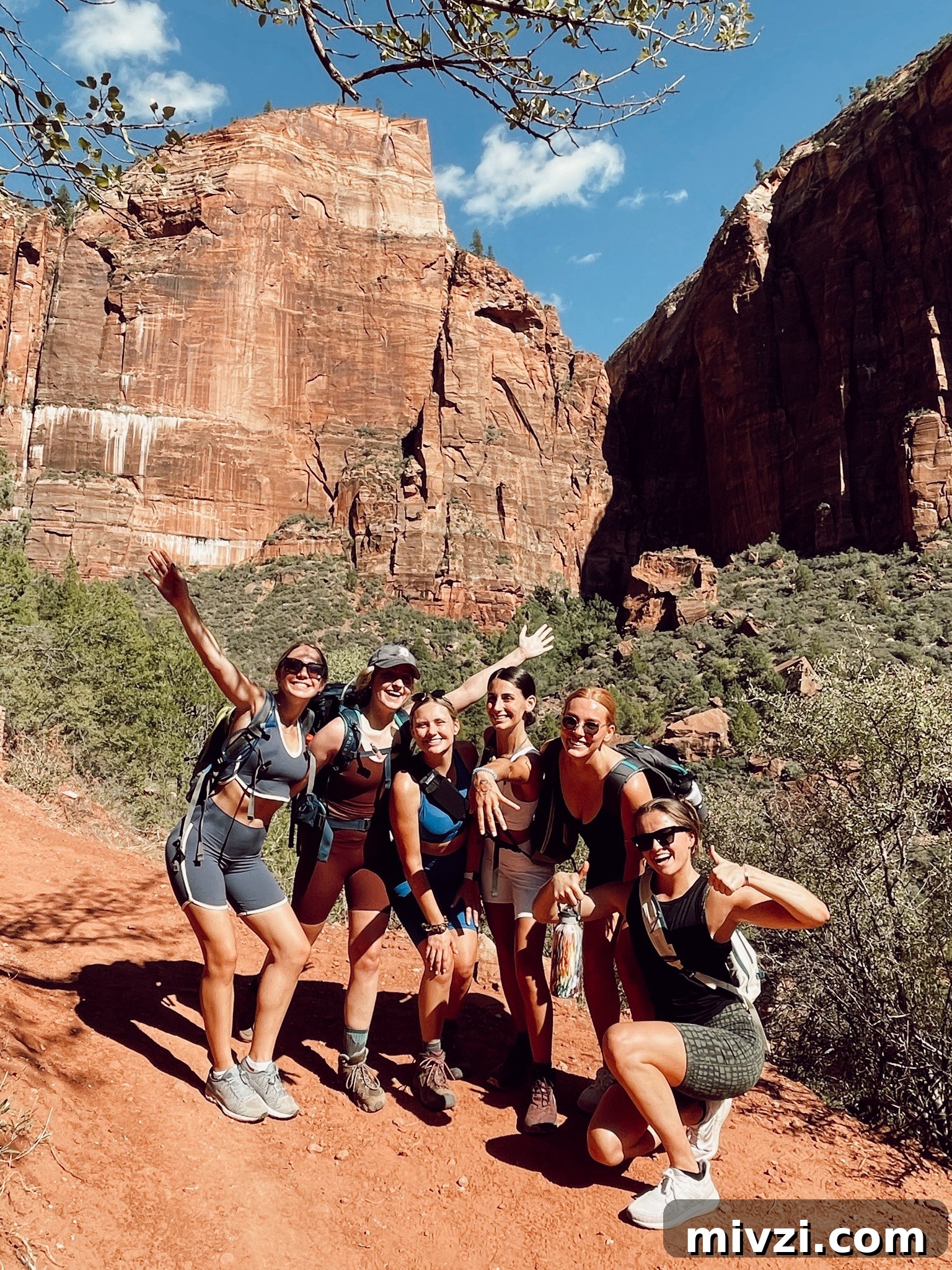 group of six ladies smiling in front of a large mountain in Zion National Park