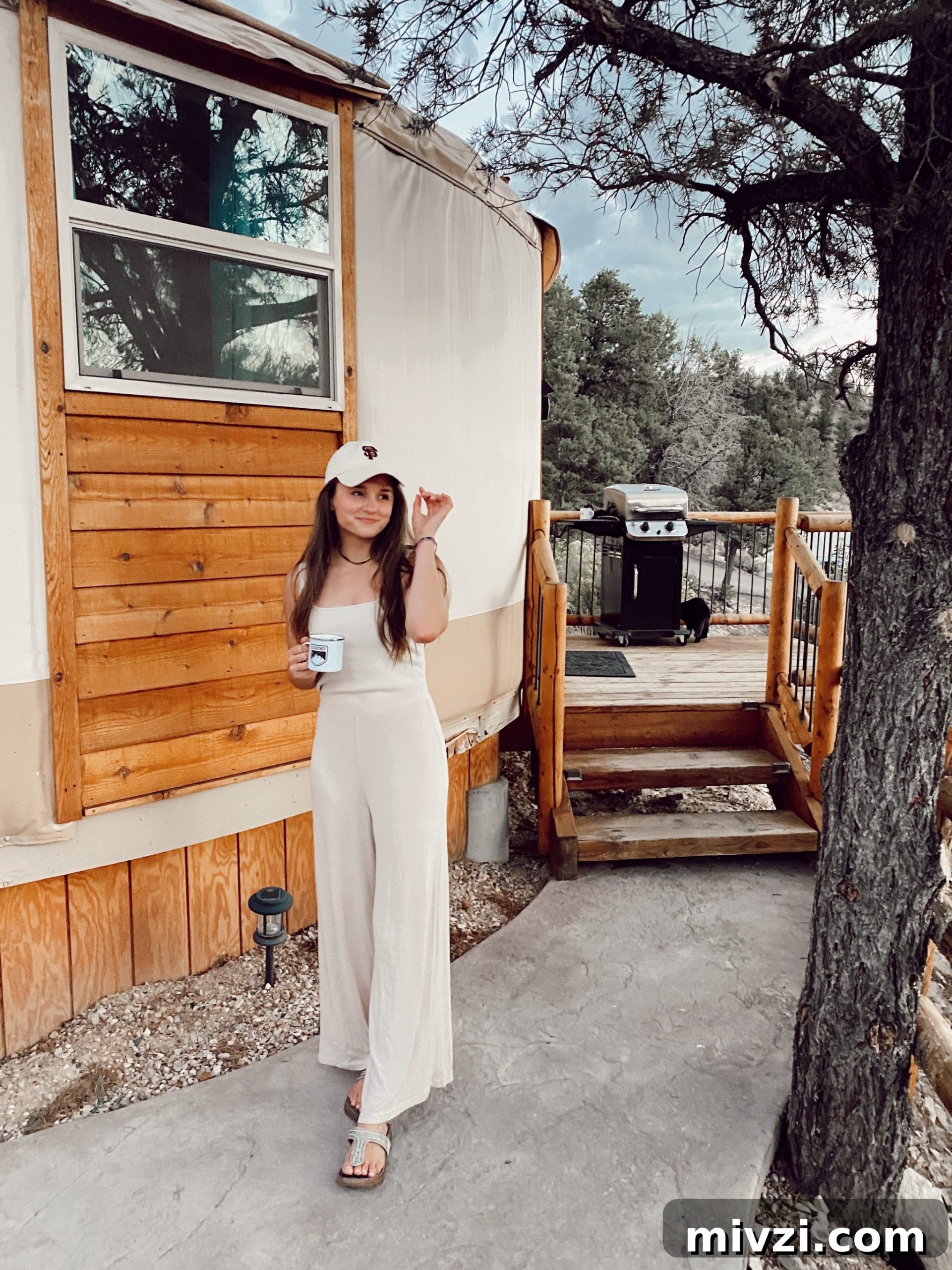 girl in neutral jumpsuit holding her campfire mug