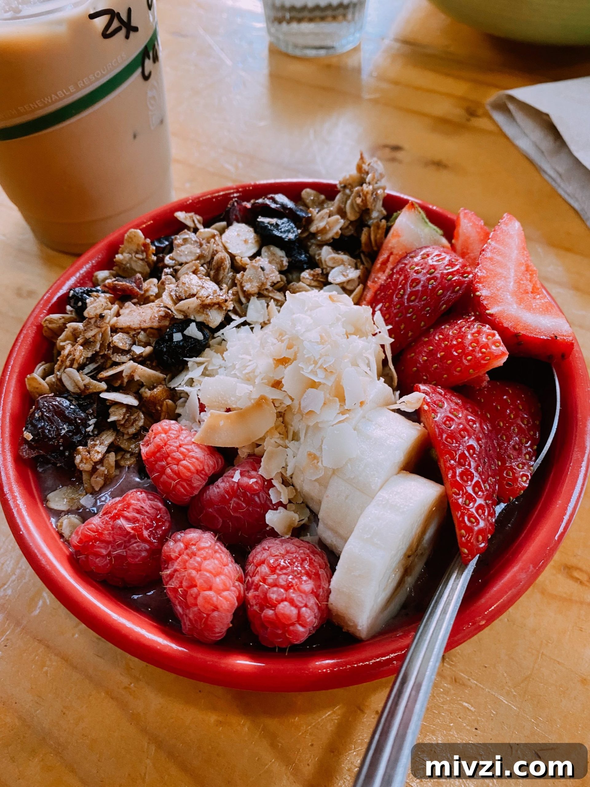 fruit bowl with strawberries, banana, and granola