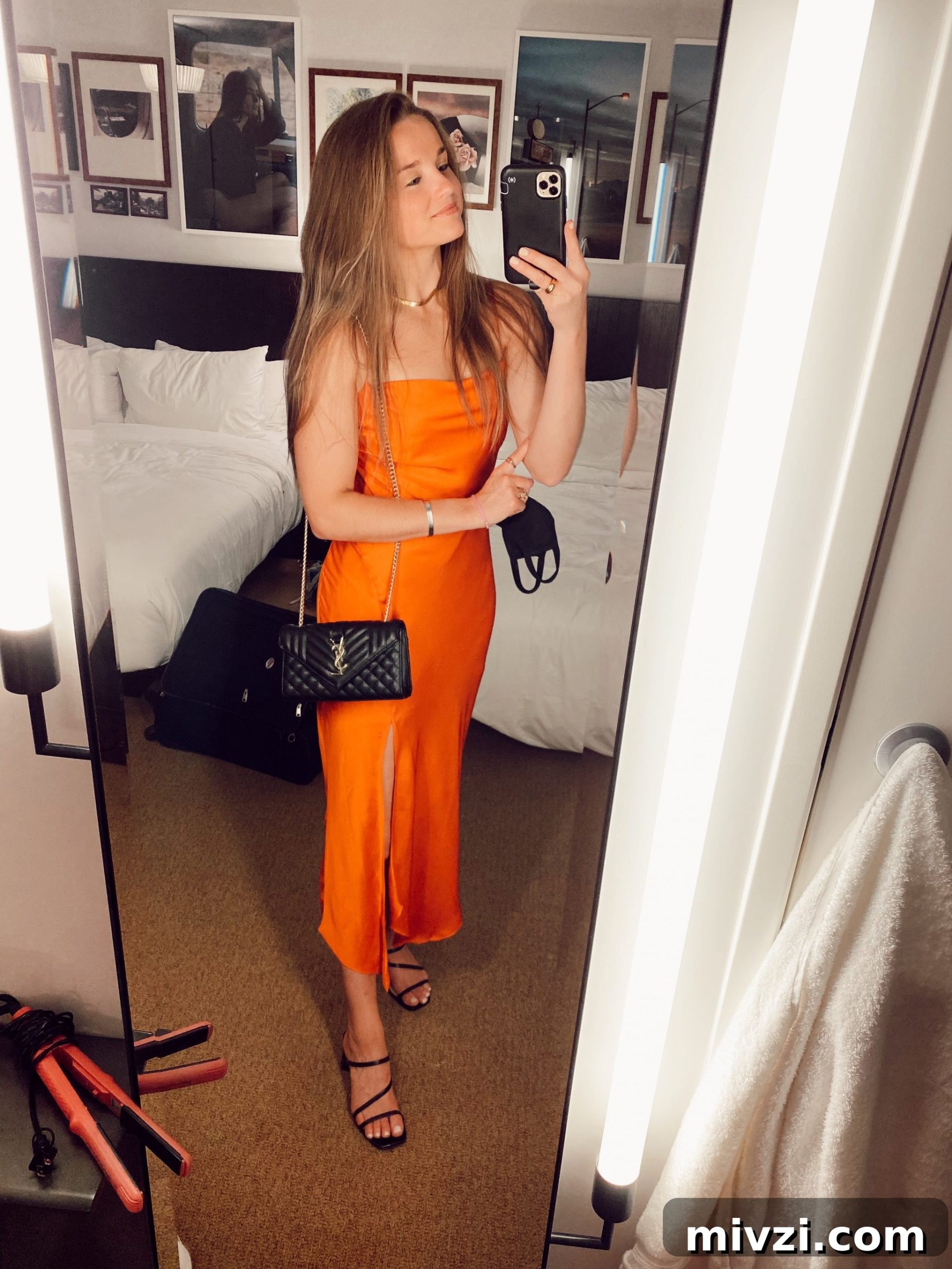 girl standing taking a mirror picture in cocktail attire