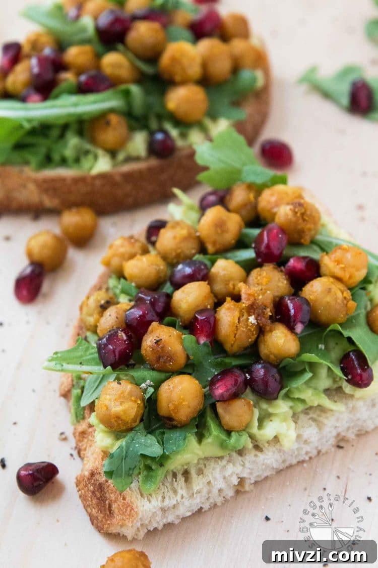 chickpea and pomegranate seeds on avocado toast