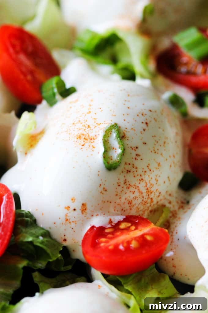 Close up photo of Eggs Mayonnaise with cherry tomatoes and scallions