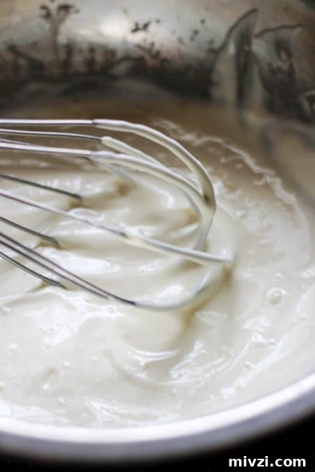 Mixing he sauce for Eggs Mayonnaise