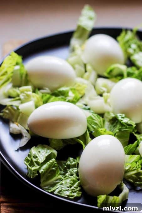 Plating eggs on a bed of lettuce for Eggs Mayonnaise
