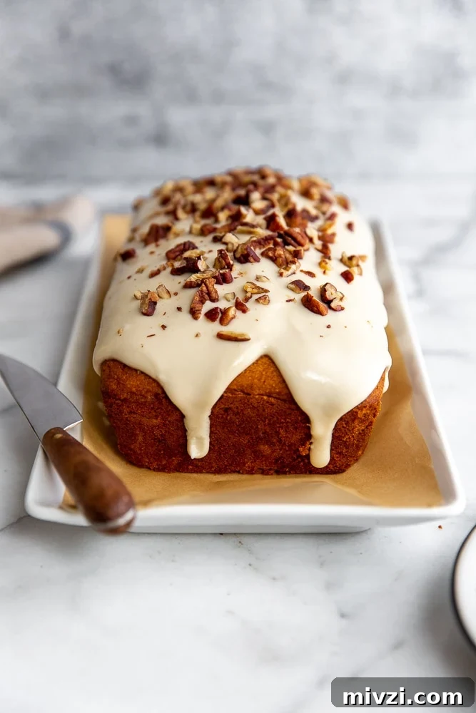 Pumpkin Pound Cake with Bourbon Cream Cheese Frosting рецепт 2 Pumpkin pound cake with cream cheese glaze on a serving platter.