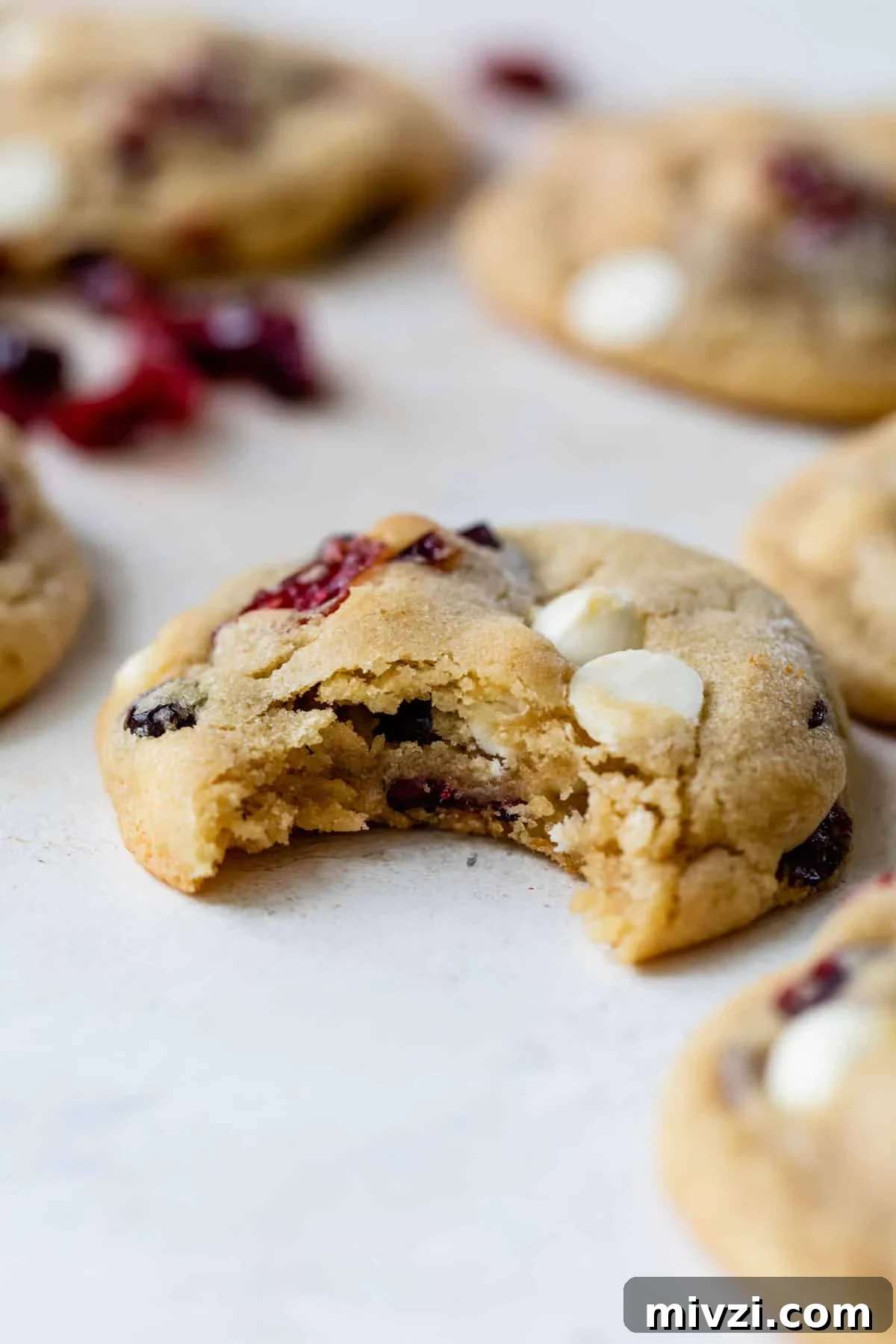 a cranberry white chocolate cookie with a bite taken out