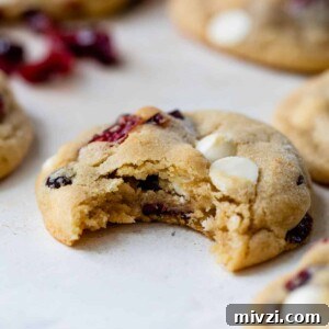 a cranberry white chocolate cookie with a bite taken out