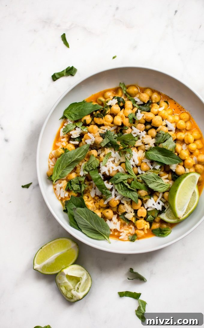 Creamy Chickpea Coconut Curry: Simple Vegan Dinner Recipe 2 a white plate with chickpea coconut curry and lime wedges