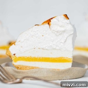 Slices of lemon meringue ice cream pie on dessert plates.