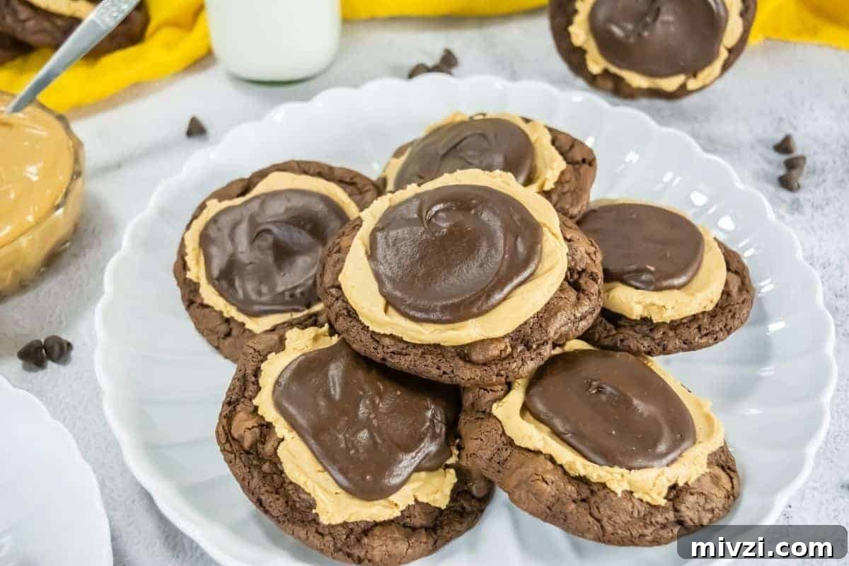 37 Winter Olympics Dishes to Warm Cold Nights and Long Broadcasts 12 A plate with several Crumbl Copycat Buckeye Brownie cookies topped with a layer of peanut butter and a swirl of chocolate frosting.