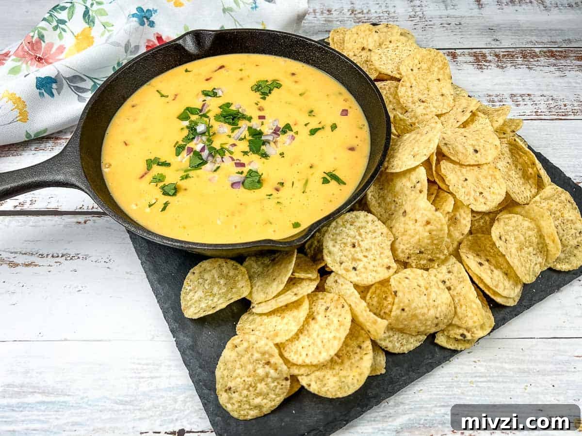 37 Winter Olympics Dishes to Warm Cold Nights and Long Broadcasts 15 Velveeta queso in a skillet with tortilla chips and lime wedges.