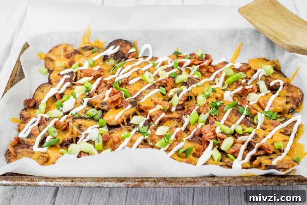 37 Winter Olympics Dishes to Warm Cold Nights and Long Broadcasts 21 Tray of Irish nachos topped with green onions, bacon, cheese, and drizzled with sour cream.