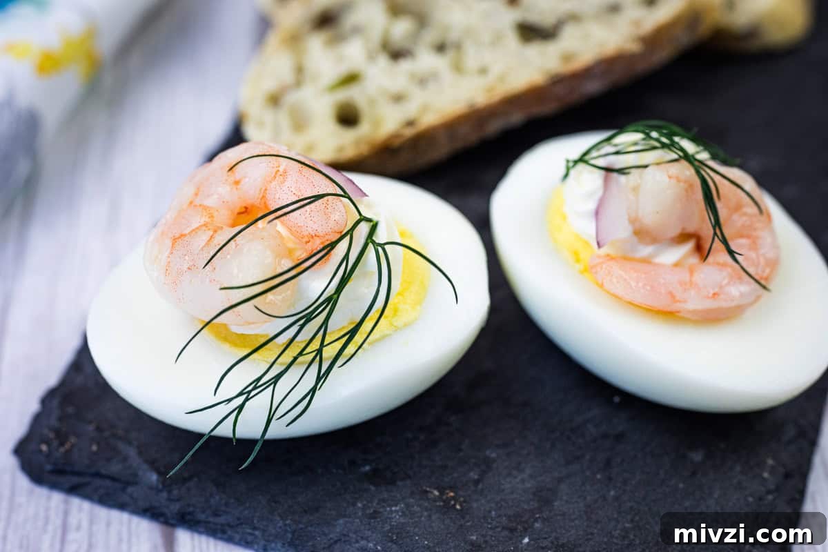 37 Winter Olympics Dishes to Warm Cold Nights and Long Broadcasts 28 Two Pickled Shrimp Egg Shooter halves were placed on a slate board, next to slices of bread.