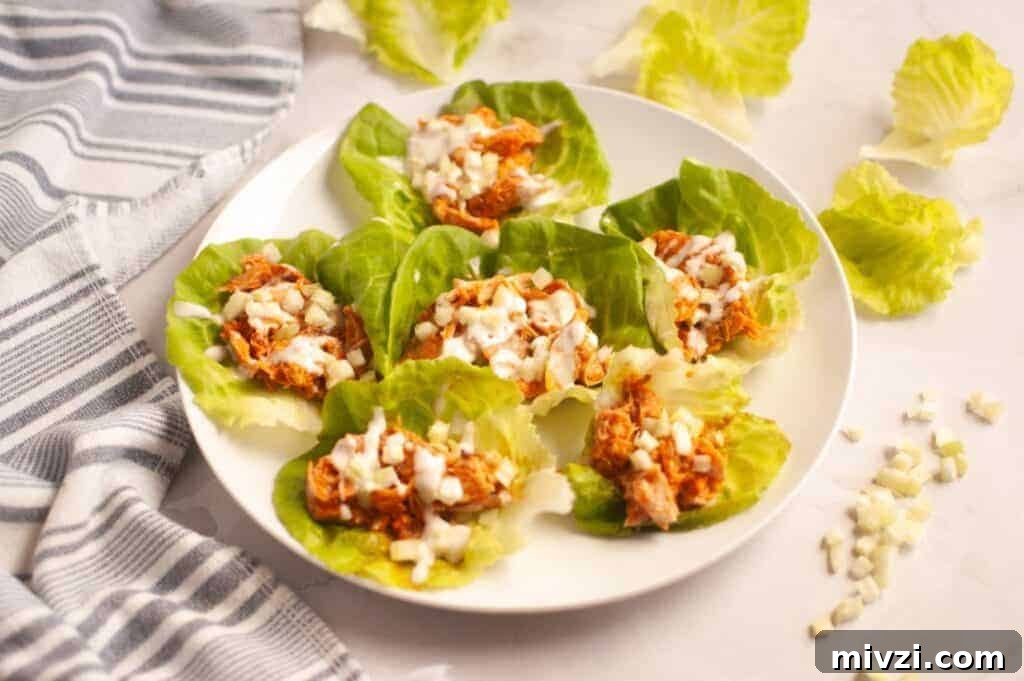 37 Winter Olympics Dishes to Warm Cold Nights and Long Broadcasts 29 A white plate with six Buffalo Chicken Lettuce Wraps placed next to a striped towel.