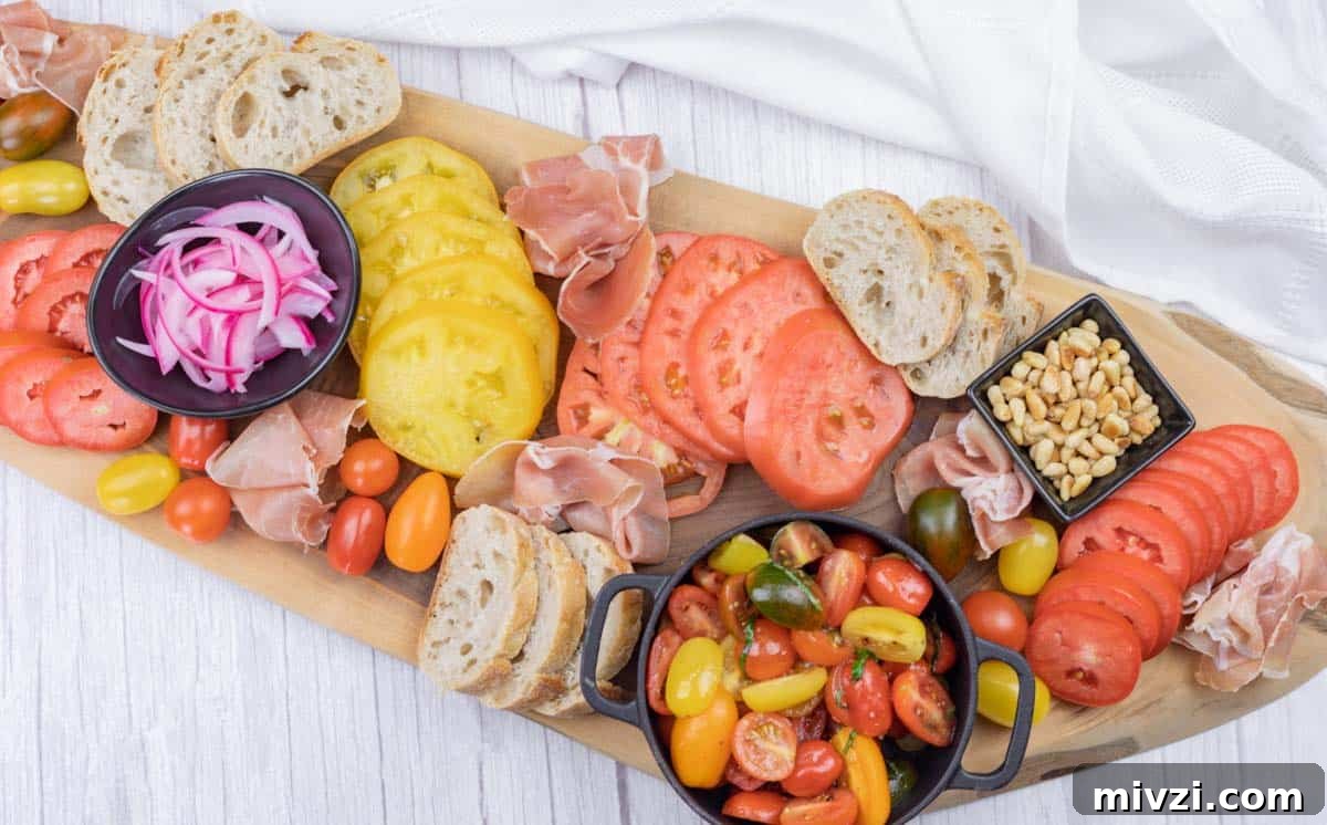 37 Winter Olympics Dishes to Warm Cold Nights and Long Broadcasts 33 A wooden board with sliced bread, red and yellow tomato slices, cured meat, pickled onions, pine nuts, and a bowl of mixed cherry tomatoes.
