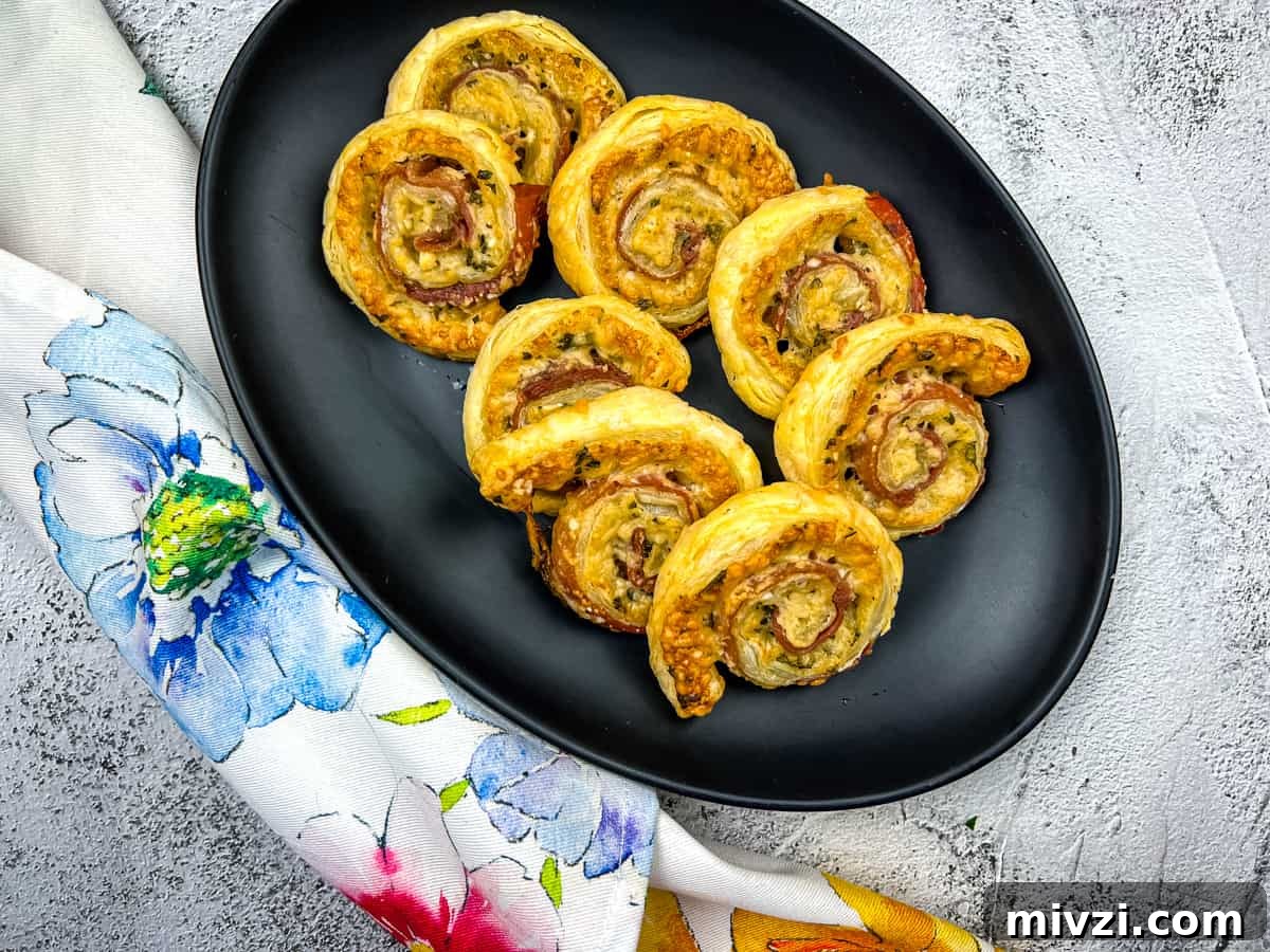37 Winter Olympics Dishes to Warm Cold Nights and Long Broadcasts 34 A plate of Prosciutto & Parmesan Puff Pastry pinwheels.