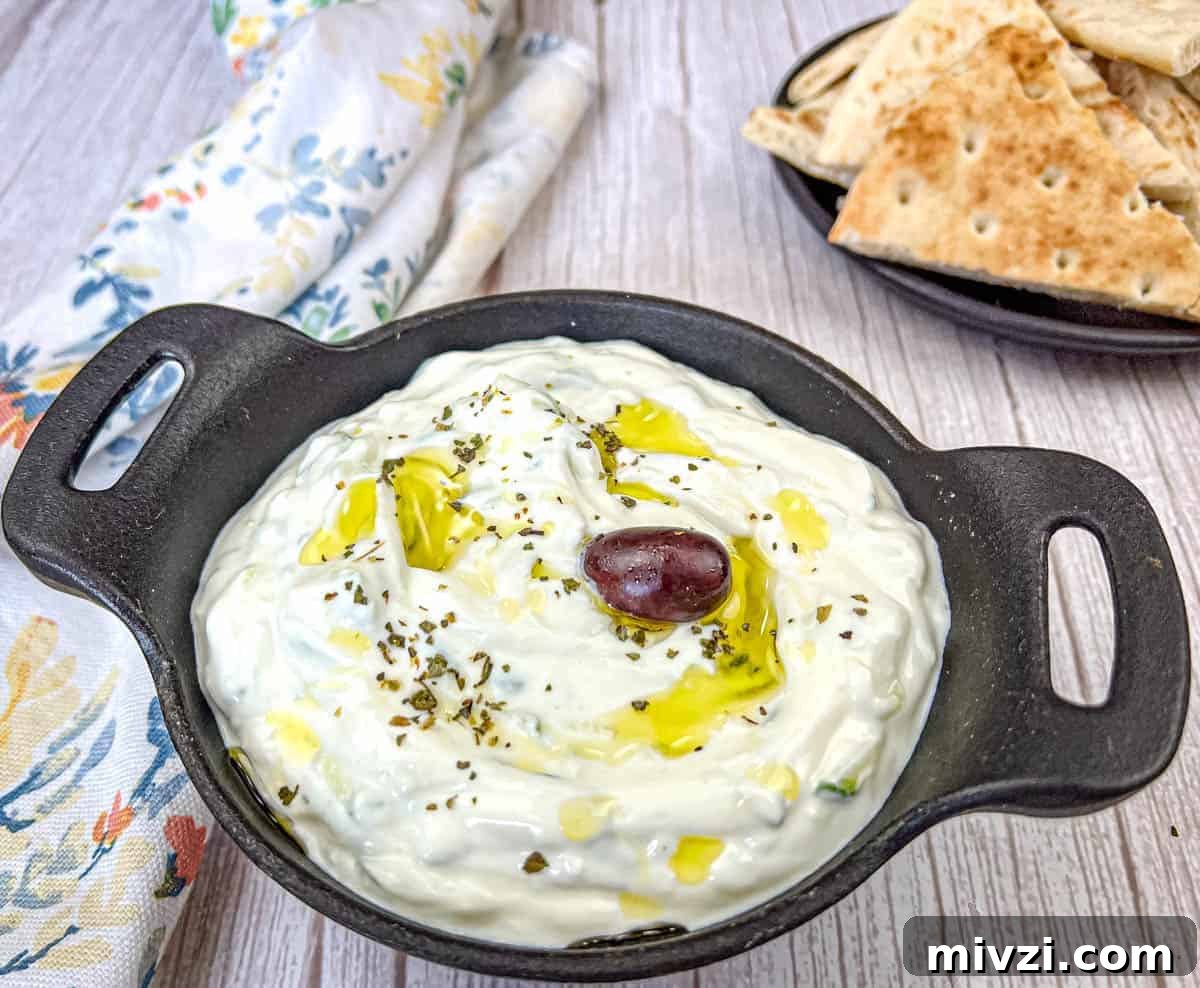 37 Winter Olympics Dishes to Warm Cold Nights and Long Broadcasts 35 Tzatziki Sauce on a black bowl.