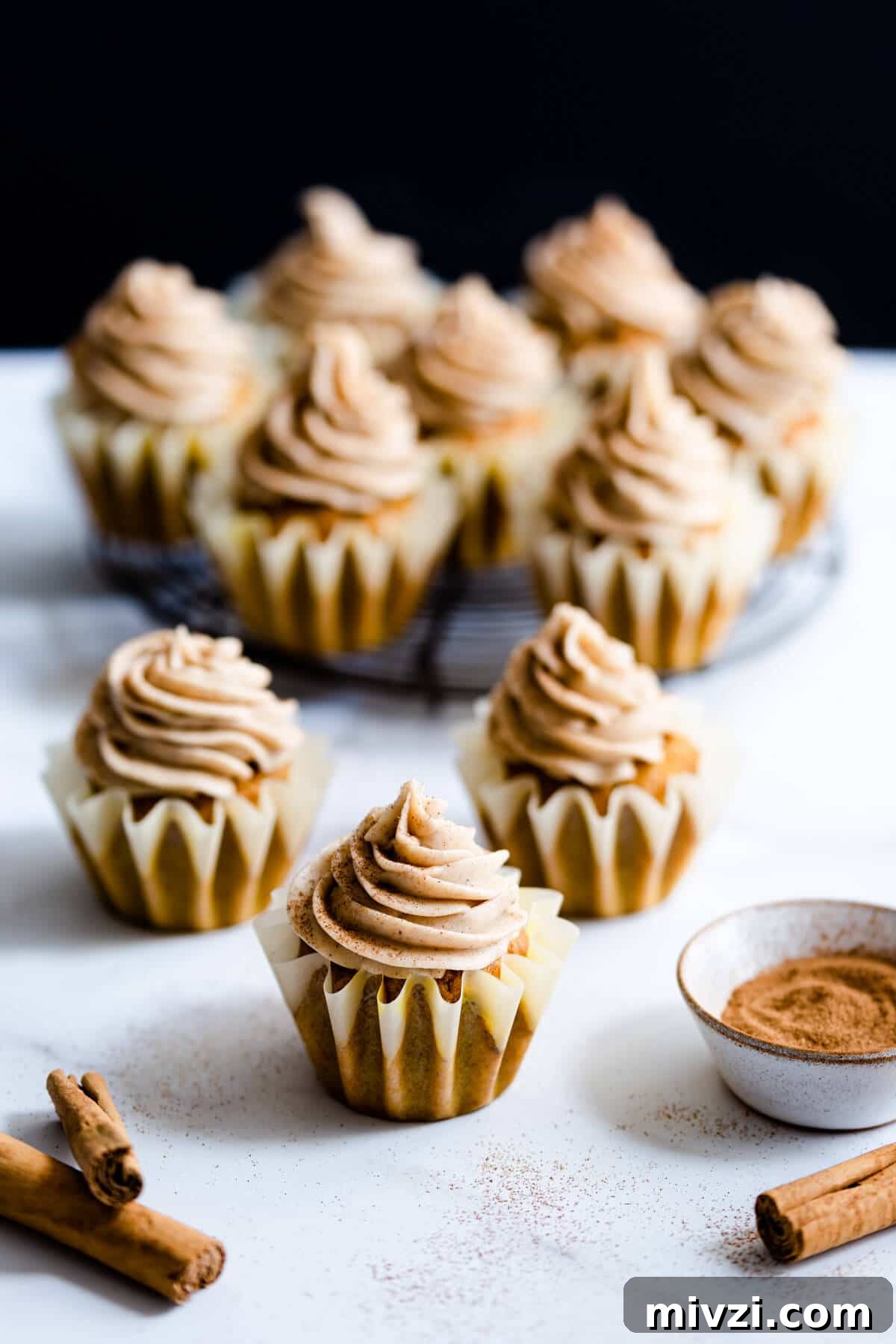 side shot of cupcakes topped with chai frosting