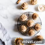 top view of pumpkin cupcakes with chai frosting on a marble surface