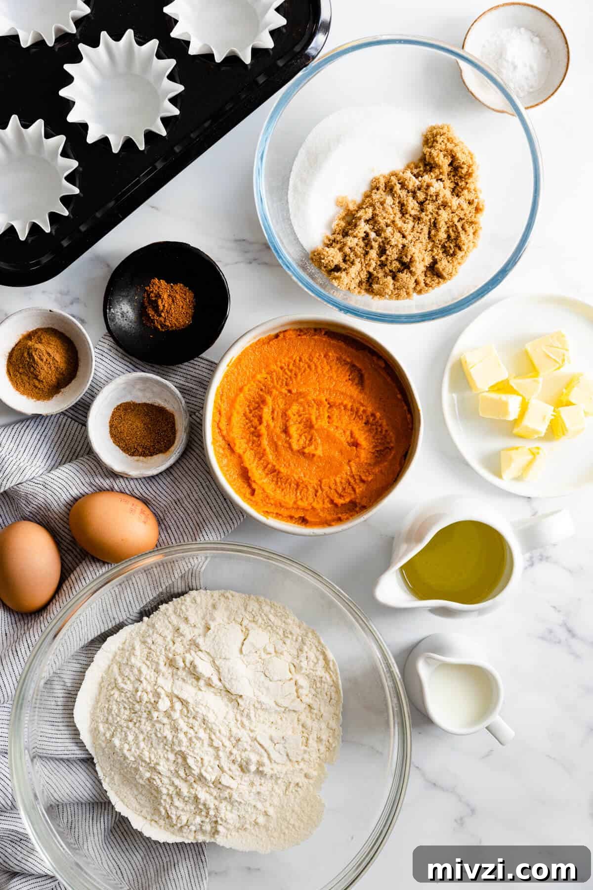 top view of bowls with ingredients for pumpkin and chai cupcakes