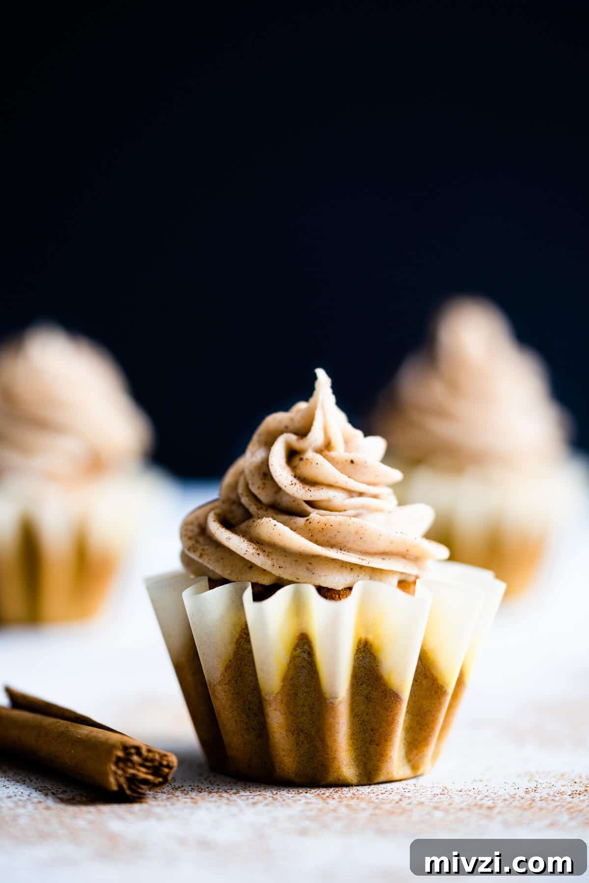 close up of a single pumpkin and chai cupcake sprinkled with cinnamon