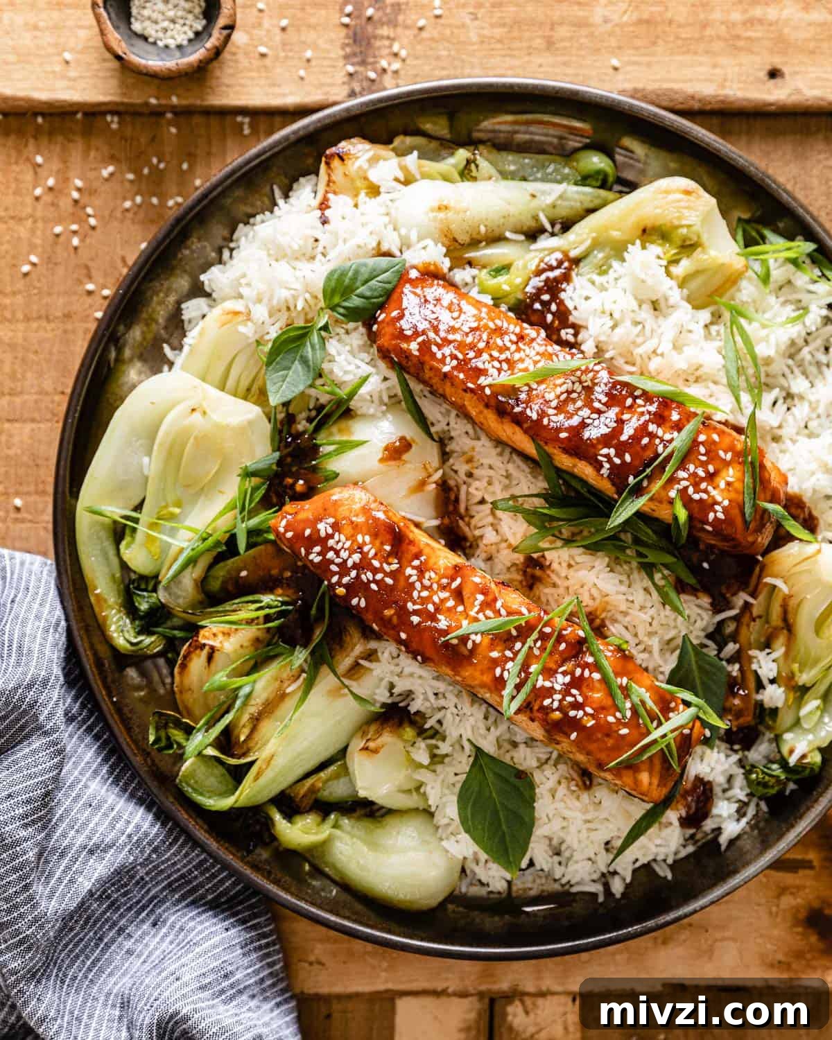 overhead of teriyaki salmon air fryer over rice and bok choy
