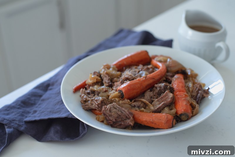 Dutch oven roasted beef and carrot is served in a platter.