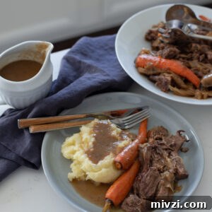 The Simplest Beef Pot Roast is served with mashed potato, Au Jus, and carrot.