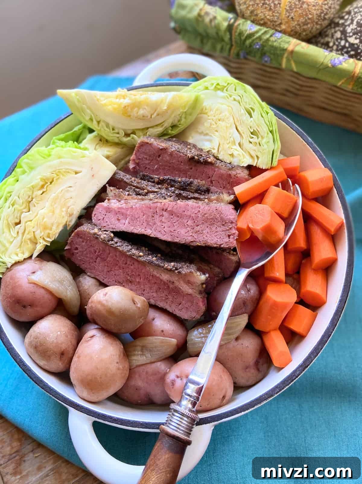 Slow Cooker Corned Beef and Cabbage Recipe for Tender, Juicy Results 2 Corned beef, cabbage, carrots and potatoes in stockpot with serving spoon.