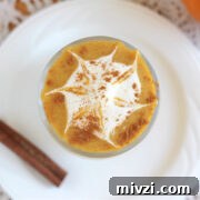 18 Creamy Smoothies Without Banana: Delicious Dairy-Free Recipes 15 Overhead shot of an orange smoothie with a whipped cream spiderweb.