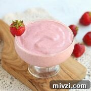 18 Creamy Smoothies Without Banana: Delicious Dairy-Free Recipes 17 Strawberry chia frosty in a glass surrounded by strawberries.