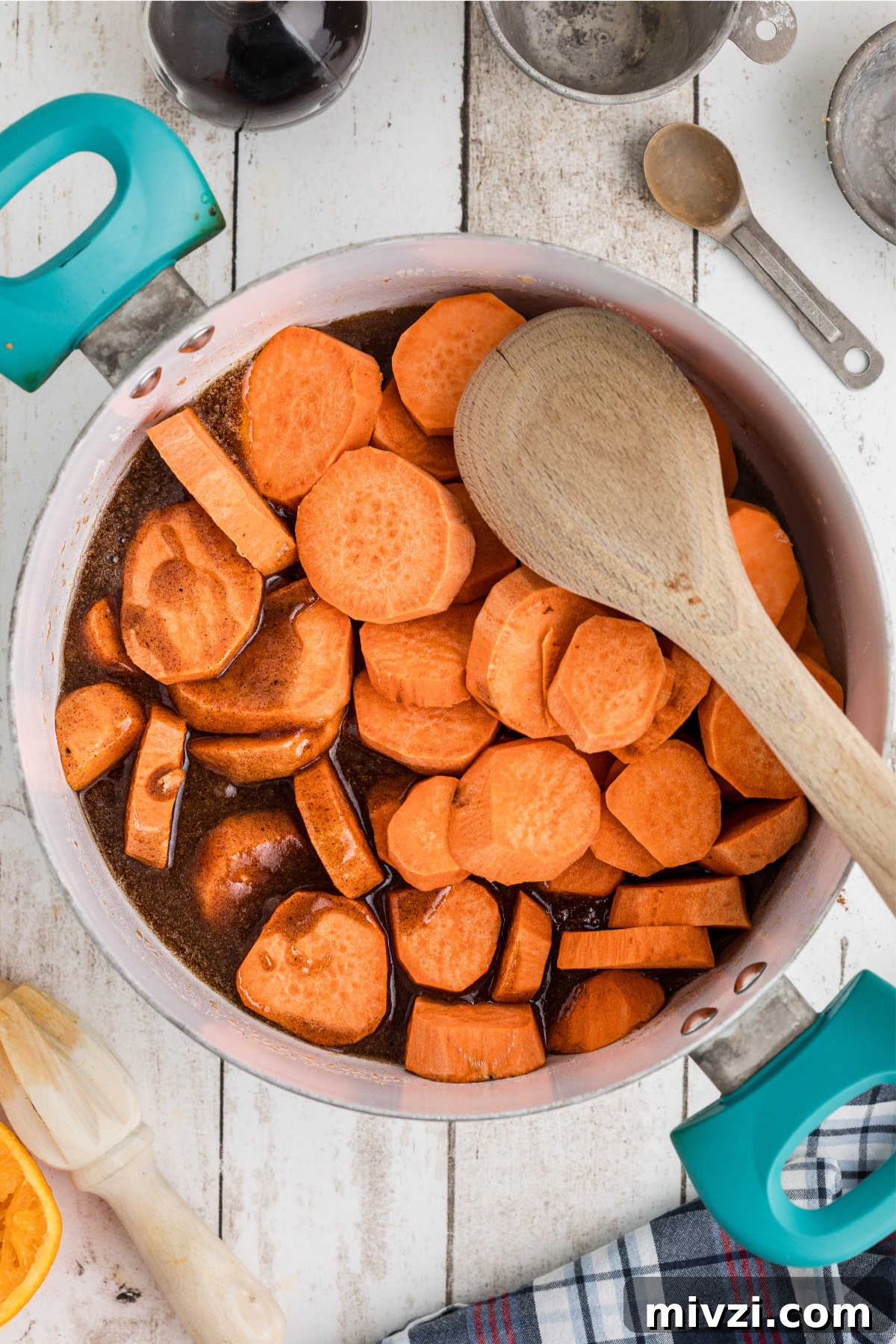 Southern-Style Candied Yams with Brown Sugar Glaze 6 Yam slices being added to a pot with melted butter and sugar.