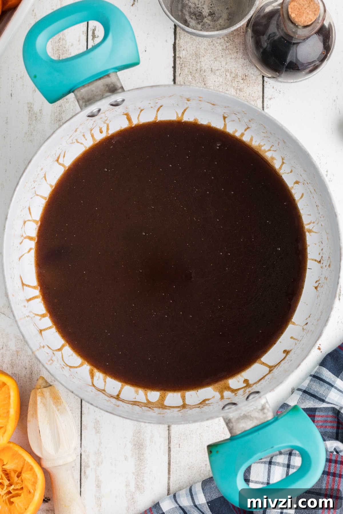 Southern-Style Candied Yams with Brown Sugar Glaze 9 A pot with a treacle like substance.
