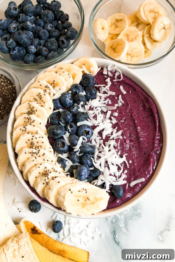 blueberry smoothie bowl with sliced bananas, fresh blueberries, and chia seeds.
