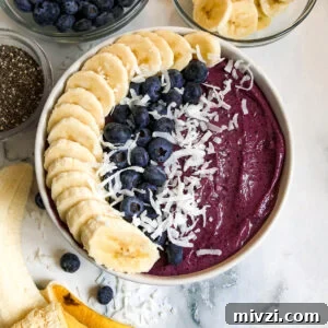blueberry smoothie bowl with sliced bananas, fresh blueberries, and chia seeds.