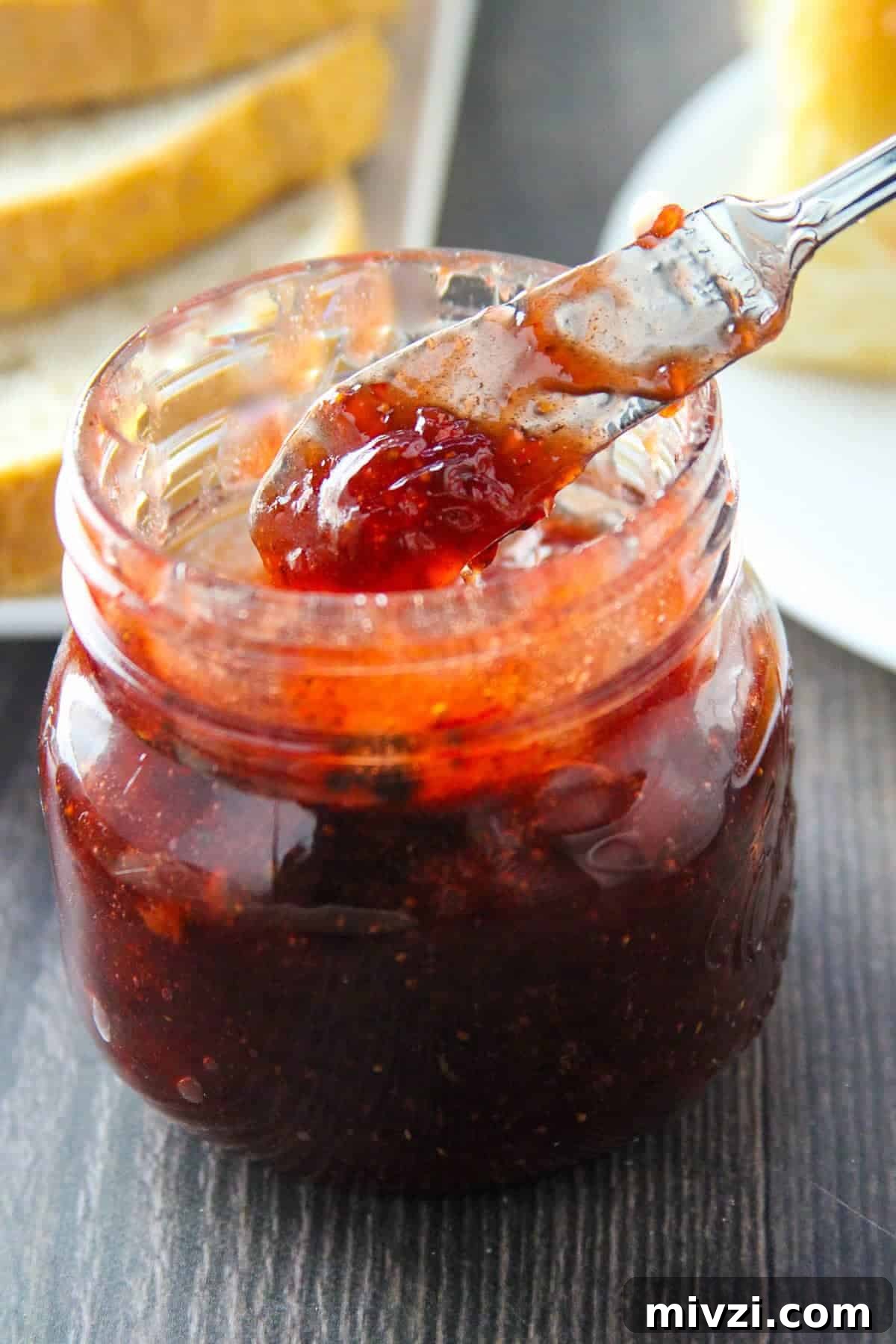 Strawberry Jam with Cracked Black Pepper: Sweet & Spicy Preserve 2 Serving Black Pepper Strawberry Jam from mason jar with a spoon