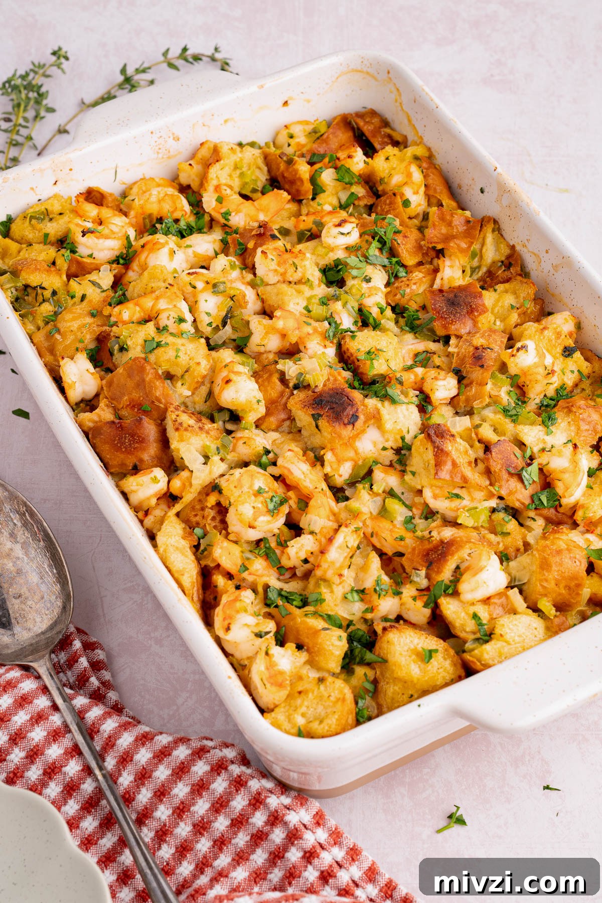 Savory Seafood Stuffing Recipe for Holidays and Dinner 4 The casserole dish with baked seafood stuffing sits on a countertop for serving.