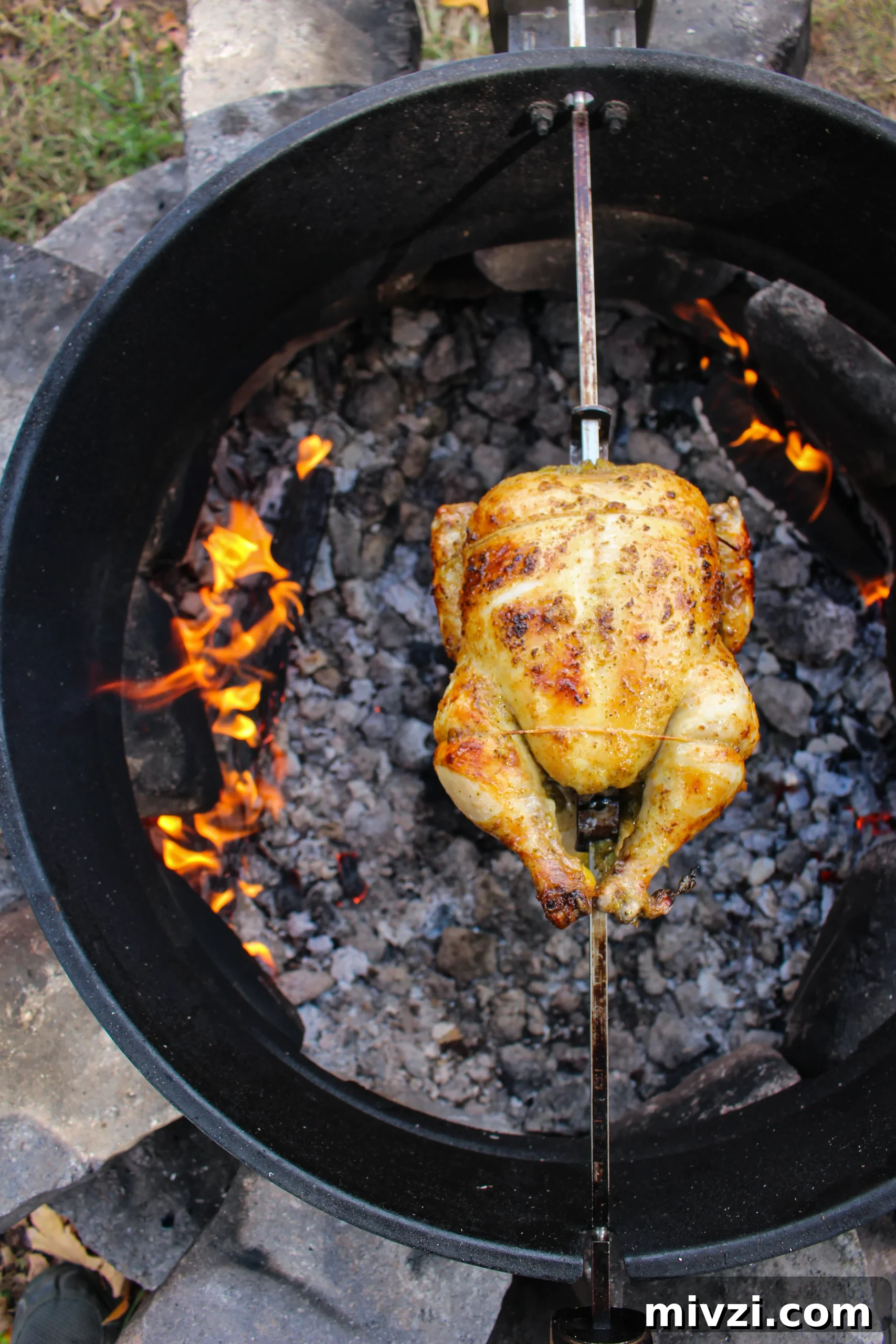 An overhead shot of the chicken on the rotisserie. 
