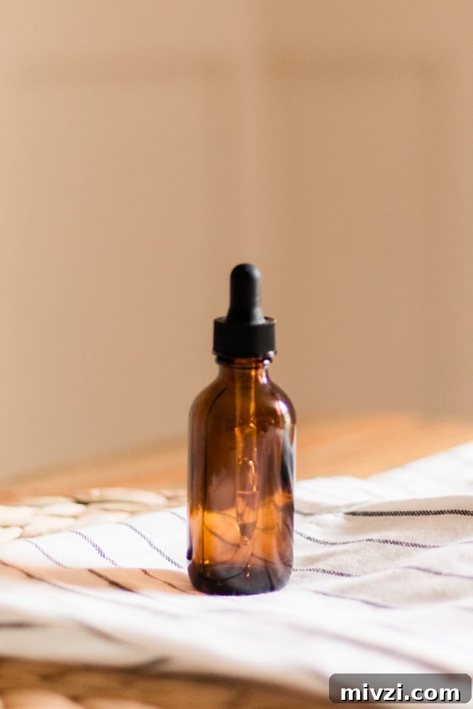 Jamaican Black Castor Oil: Uses, Benefits, and Hair Growth Tips 3 Jamaican black castor oil in amber colored dropper bottle.