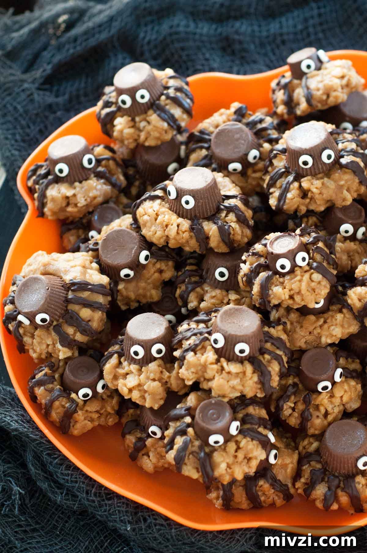 a plate of gluten-free Halloween spider cookies on a orange plate