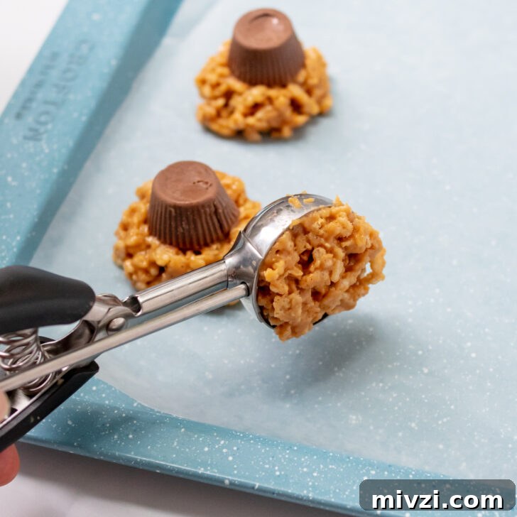 a cookie scoop portioning out the crispy rice cookie.